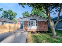 Charming brick home featuring a well-manicured lawn and a quaint bay window at 608 Manhattan Ave, Indianapolis, IN 46241