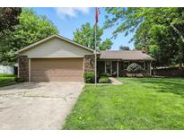 Charming single-Gathering home featuring a brick exterior, attached garage, and a well-manicured front lawn at 610 Front Royal Dr, Indianapolis, IN 46227