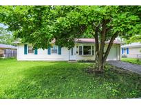 Charming home with well-maintained lawn and mature tree at 6108 Penway St, Indianapolis, IN 46224