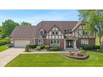 Charming Tudor style home with well-manicured lawn, mature trees, and beautiful landscaping at 625 La Placita St, Greenwood, IN 46143