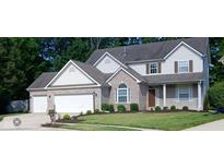 Charming two-story home with a brick facade, white siding, attached garage, and well-manicured lawn at 6483 Timber Walk Dr, Indianapolis, IN 46236