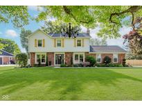 Charming two-story home featuring a well-manicured lawn and classic architectural details at 8201 Castle Dr, Indianapolis, IN 46256