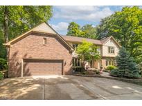 Beautiful brick and siding home with an attached two-car garage and a manicured front yard at 10518 Courageous Dr, Indianapolis, IN 46236