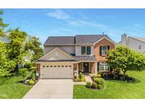Charming two-story home boasts a brick and siding facade, well-manicured lawn, and attached two-car garage at 14052 Rayners Ln, Fishers, IN 46037