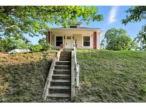 Charming home featuring a landscaped front yard and inviting front porch at 1430 W 14Th St, Anderson, IN 46016