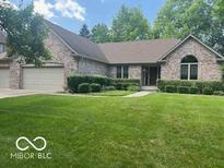 Charming single-story brick home with well-manicured lawn and mature landscaping, plus an attached two-car garage at 1456 Bent Tree Pl, Greenwood, IN 46143