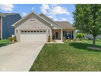 Charming home featuring a well-manicured lawn, light brick facade, and a welcoming front porch seating area at 3420 Stoddard Pl, Indianapolis, IN 46217