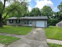 Charming single-story home with stone accents, an attached garage, and a well-maintained lawn at 4405 Phoenix Dr, Indianapolis, IN 46241