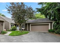 Charming home featuring a two-car garage and mature tree in a quiet neighborhood setting at 4609 Framington Ct, Indianapolis, IN 46254