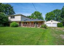 Charming brick and vinyl home with a covered front porch and spacious lawn with detached garage at 5081 N 500 W, Fairland, IN 46126