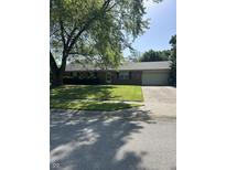 Charming brick home with a well-maintained lawn and mature trees providing ample shade at 5453 David St, Indianapolis, IN 46226