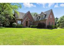 Stunning brick home with lush green lawn and manicured landscaping, creating a welcoming curb appeal at 6183 Whitetail Run, Greenwood, IN 46143