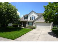 Charming two-story home with a well-manicured lawn, attached two car garage, and beautiful landscaping at 6422 Hollingsworth Dr, Indianapolis, IN 46268