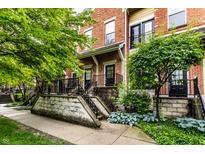 Charming brick townhomes with well-maintained landscaping and inviting entryways, creating a welcoming curb appeal at 6556 Reserve Dr, Indianapolis, IN 46220