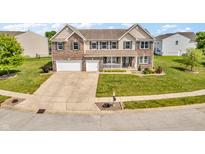 Beautiful two-story home with a well-manicured lawn, two-car garage, and inviting front porch at 7047 Lancaster Ln, Avon, IN 46123