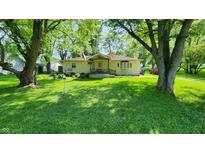 Charming single-story home featuring a welcoming front porch and a well-maintained lawn at 8201 S Burlington Dr, Muncie, IN 47302