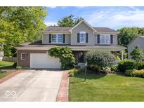 Charming two-story home with a brick and gray exterior, attached garage, and well-manicured lawn at 8827 Lindsey Ct, Fishers, IN 46038