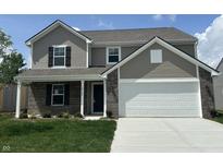 Charming two-story home features a brick and siding exterior, attached two-car garage, and well-manicured front lawn at 10144 Camp Creek Way, Indianapolis, IN 46229