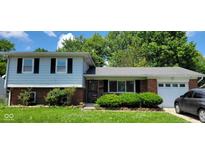 Charming two-story home with a brick facade and manicured lawn at 10210 E 33Rd St, Indianapolis, IN 46235