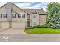 Charming two-story townhome featuring a well-manicured lawn and attached two-car garage at 1139 Fernwood Way, Plainfield, IN 46168
