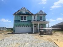 Two-story home with attached garage and green protective wrap at 114 Velvet Hat Rd, Danville, IN 46122
