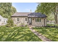 Charming stone home with a well-maintained lawn and walkway leading to the front door at 1205 Park Dr, Lebanon, IN 46052