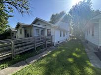 Quaint home with a ramp that leads up to the front porch and mature trees in a peaceful neighborhood at 2509 S New Jersey St, Indianapolis, IN 46225
