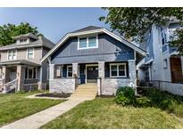 Charming two-story home with blue siding, white brick accents, and a well-manicured lawn at 2954 N Washington Blvd, Indianapolis, IN 46205