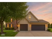 Charming home featuring a brick and vinyl exterior with a spacious three-car garage and well-maintained lawn at 301 Cobblesprings Ct, Avon, IN 46123