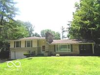 Charming home with a brick chimney and well-maintained lawn at 3253 W 34Th St, Indianapolis, IN 46222