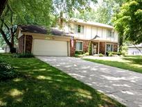 Charming two-story home with a well-maintained lawn, a two-car garage, and classic brick accents at 336 N Windsong Ln, Greenwood, IN 46142