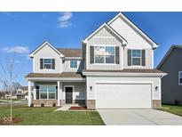 Charming two-story home featuring a two-car garage and a beautifully maintained lawn at 379 Antioch St, Greenfield, IN 46140