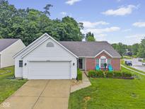 Charming single-story home with a well-manicured lawn and inviting curb appeal at 3843 Grove Tree Ln, Indianapolis, IN 46203