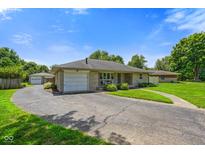 Charming single-story home featuring a stone facade, attached garage, and spacious circular driveway at 45 Kirk E Dr, Indianapolis, IN 46234