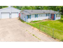 Charming single-story home with a large detached garage and a spacious concrete driveway at 4644 E 150 N, Anderson, IN 46012