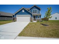 Charming two-story home with blue siding, brick accents, a spacious driveway, and manicured lawn at 507 Redvine Dr, Sheridan, IN 46069