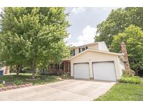 Charming two-story home with a well-maintained lawn and two-car garage at 6028 Thornwood Ct, Indianapolis, IN 46250