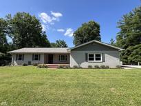 Charming single-story home featuring a well-maintained lawn, brick accents, and a welcoming front porch at 6238 E Southport Rd, Indianapolis, IN 46237