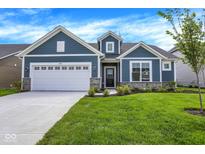 Charming blue home with a white garage door, stone accents, and a well-manicured lawn at 7195 Rose Hill Ave, Brownsburg, IN 46112
