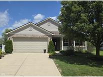 Charming home showcasing a well-manicured lawn, complemented by a spacious two-car garage at 7608 Mather Ln, Indianapolis, IN 46239