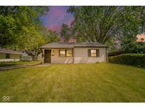 Charming single-story home with a well-maintained lawn and mature trees at 8210 Patton Dr, Lawrence, IN 46226