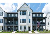 Charming new construction townhome features classic design, black windows, and inviting curb appeal at 830 Freeland Way, Carmel, IN 46032