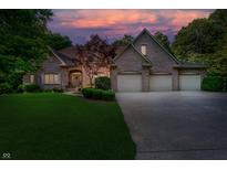 Stately brick home featuring a three-car garage and manicured lawn, perfect for suburban living at 9190 Hastings Trce, Indianapolis, IN 46234