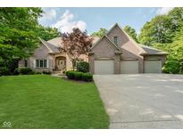 Attractive brick home featuring an attached three car garage and meticulously maintained lawn at 9190 Hastings Trce, Indianapolis, IN 46234