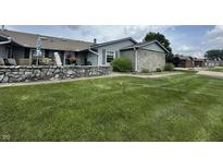 Charming home featuring stone accents, well-manicured lawn and lovely curb appeal at 1001 Paradise Ct # F, Greenwood, IN 46143