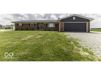 Charming brick home with a well-manicured lawn and an attached garage, perfect for comfortable living at 10769 Shelbyville Rd, Indianapolis, IN 46259