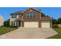 Charming two-story home with a well-manicured lawn, brick facade, and attached two-car garage at 10780 Affirmed Dr, Indianapolis, IN 46234