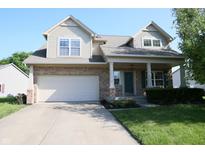 Charming two-story home featuring a brick and siding facade, attached garage, and a well-manicured front lawn at 10949 Haig Point Dr, Fishers, IN 46037
