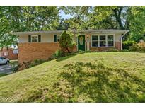 Charming brick home with well-manicured lawn and inviting front porch at 1302 N Furman Ave, Indianapolis, IN 46214