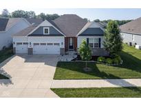 Charming home with a well-manicured lawn, two-car garage, and stylish architectural details at 16235 Natures Way, Westfield, IN 46074